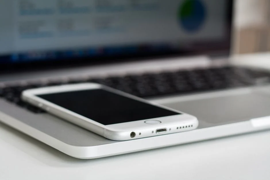 A contemporary workspace showcasing a laptop, tablet, and smartphones, ideal for tech and freelance use.